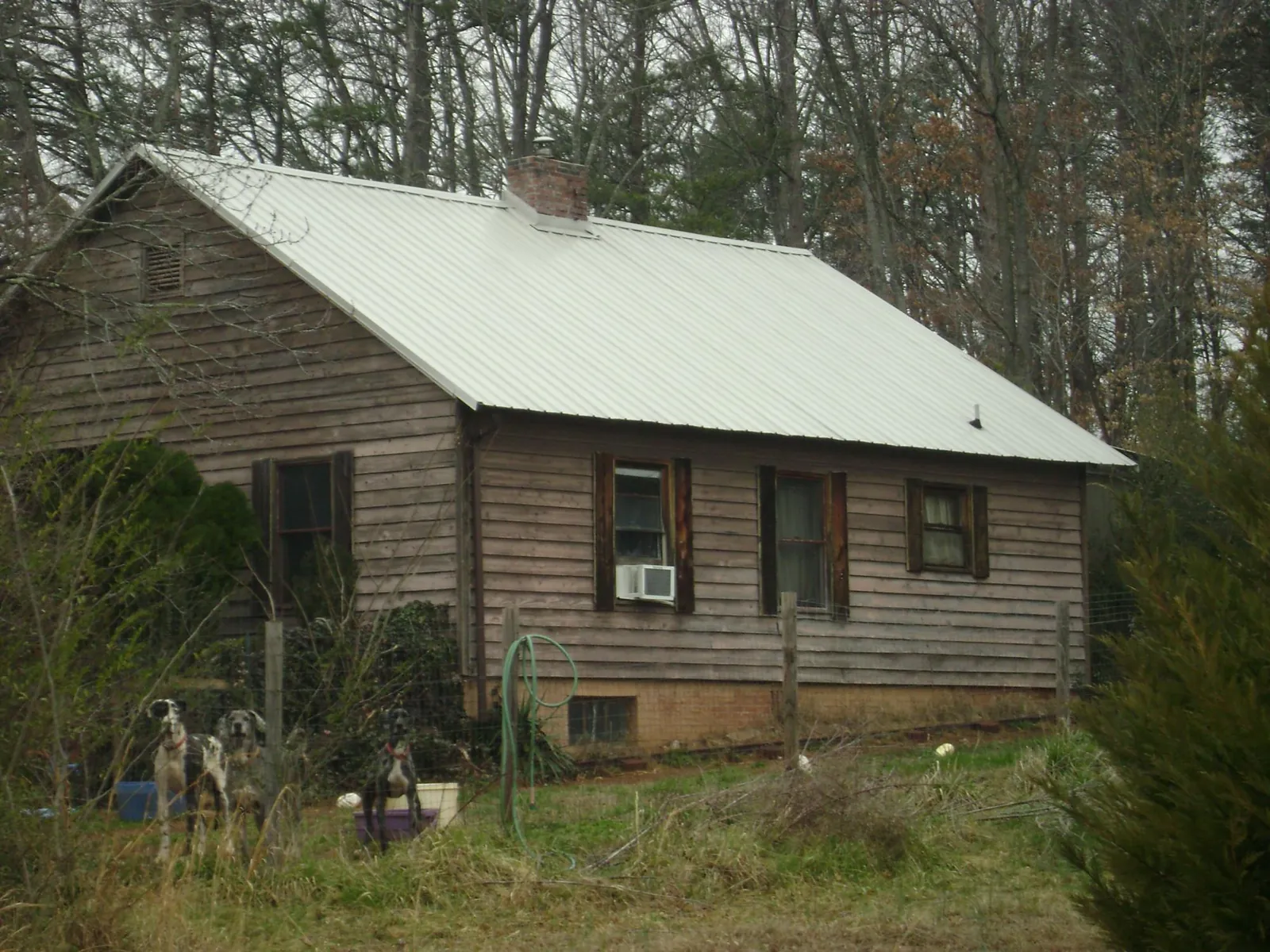 White metal roof on an old wood sided farmhouse, from a Metal Roof Installation job in Bellport